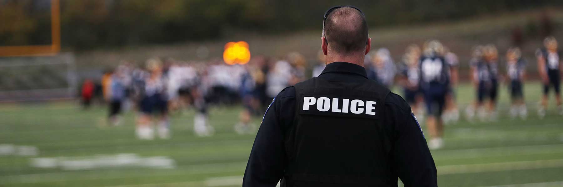 School resource officer looking at students.