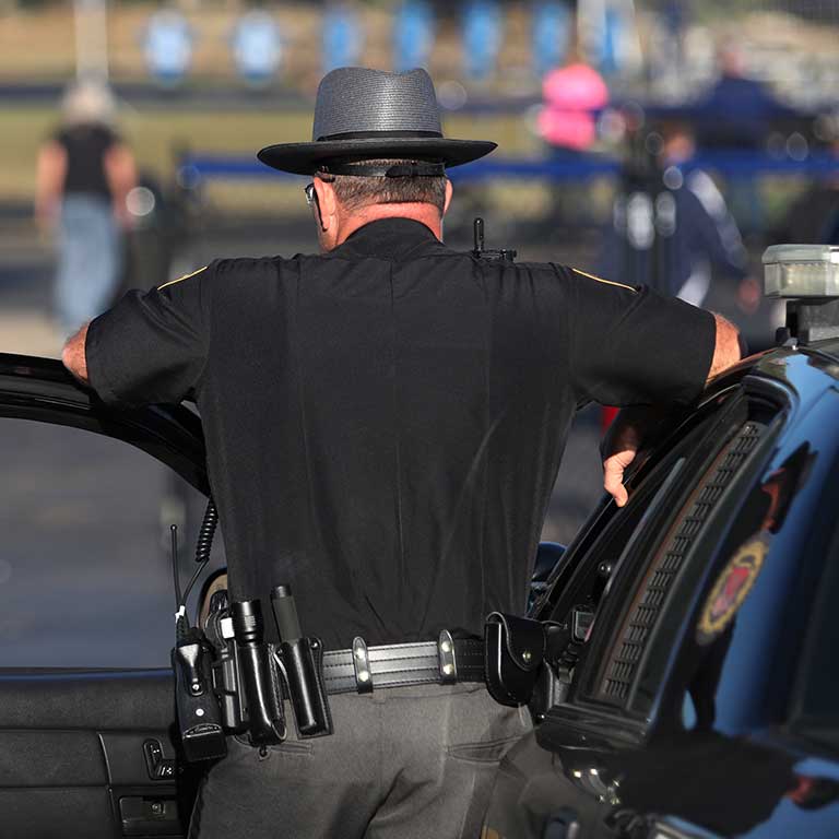 School resource officer looking at students.